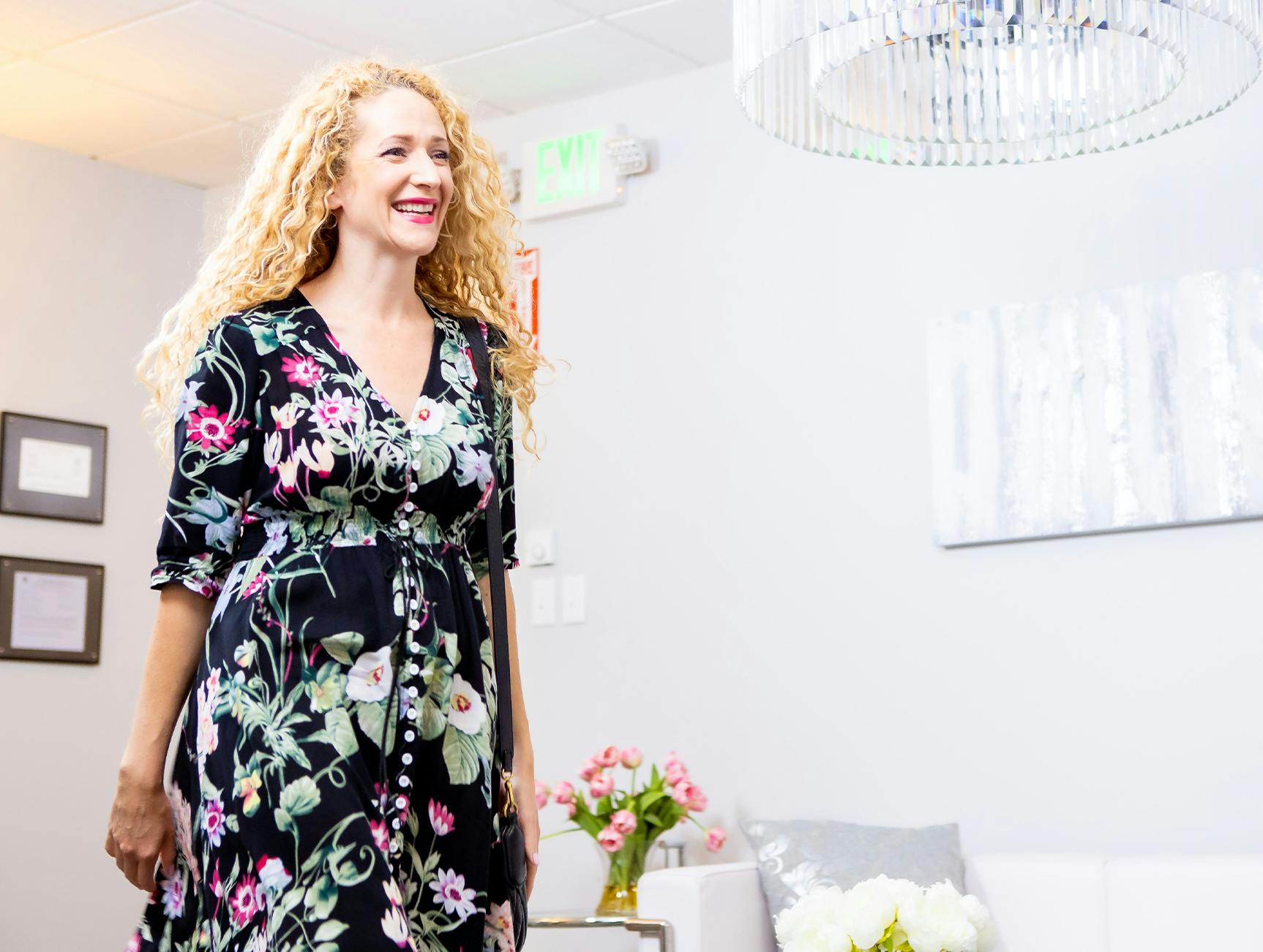 Woman in a floral dress smiling