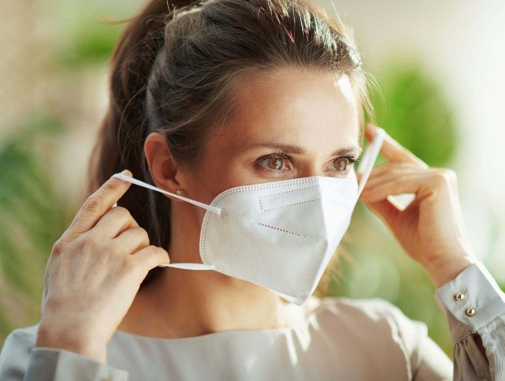 Woman putting on a mask