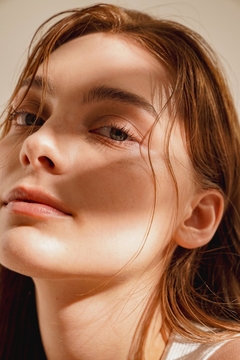 Close up of young woman with beautiful glowing skin in studio shoot