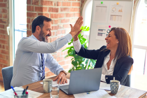 Two co-workers high fiving each other