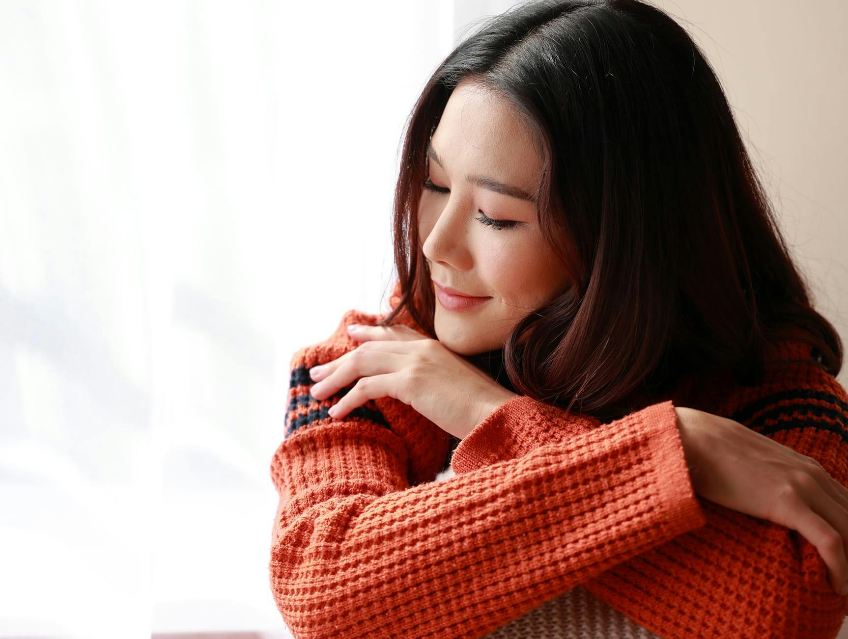 woman in orange sweater