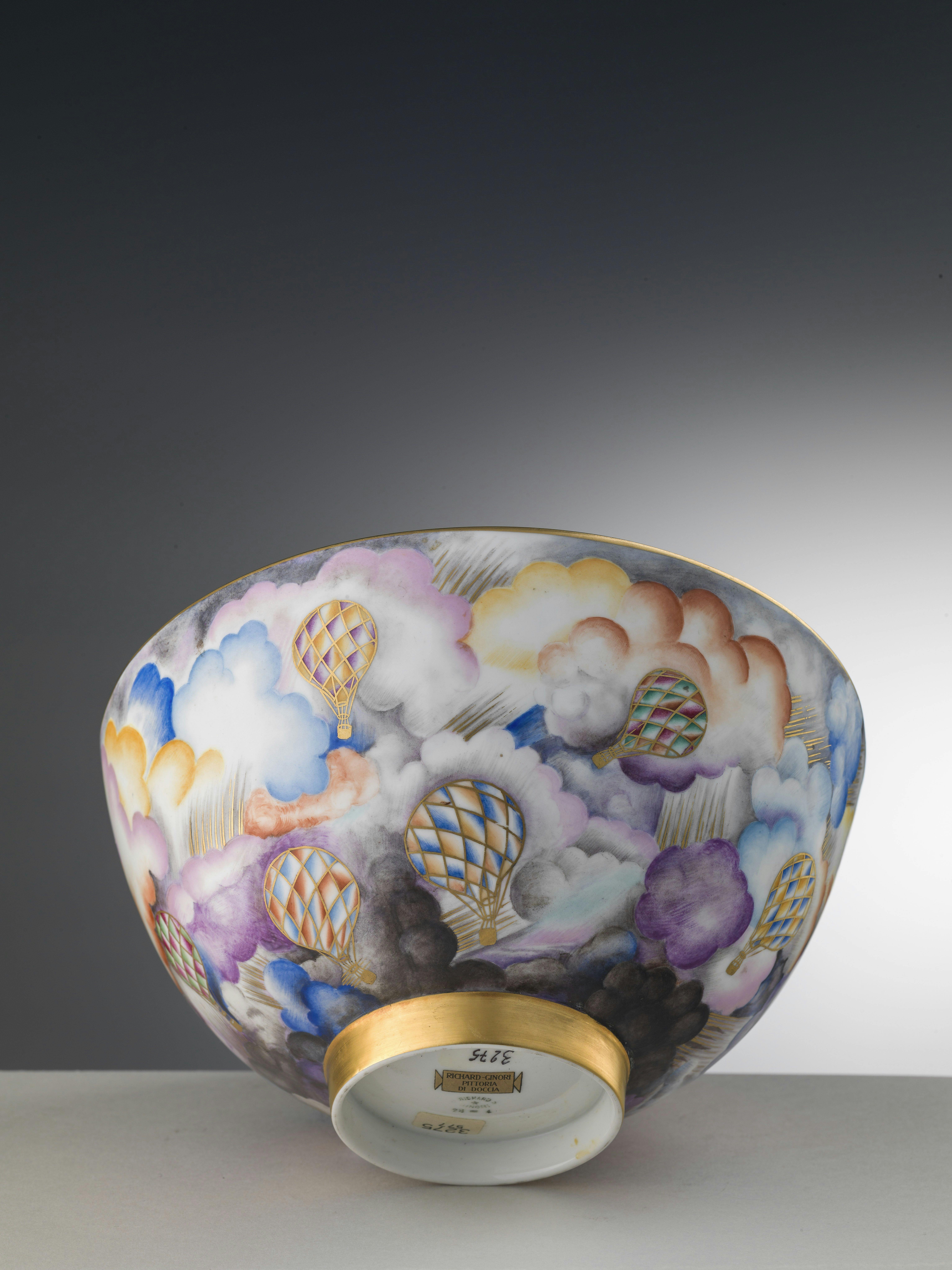 White bowl decorated with a stormy sky with clouds and hot-air balloons