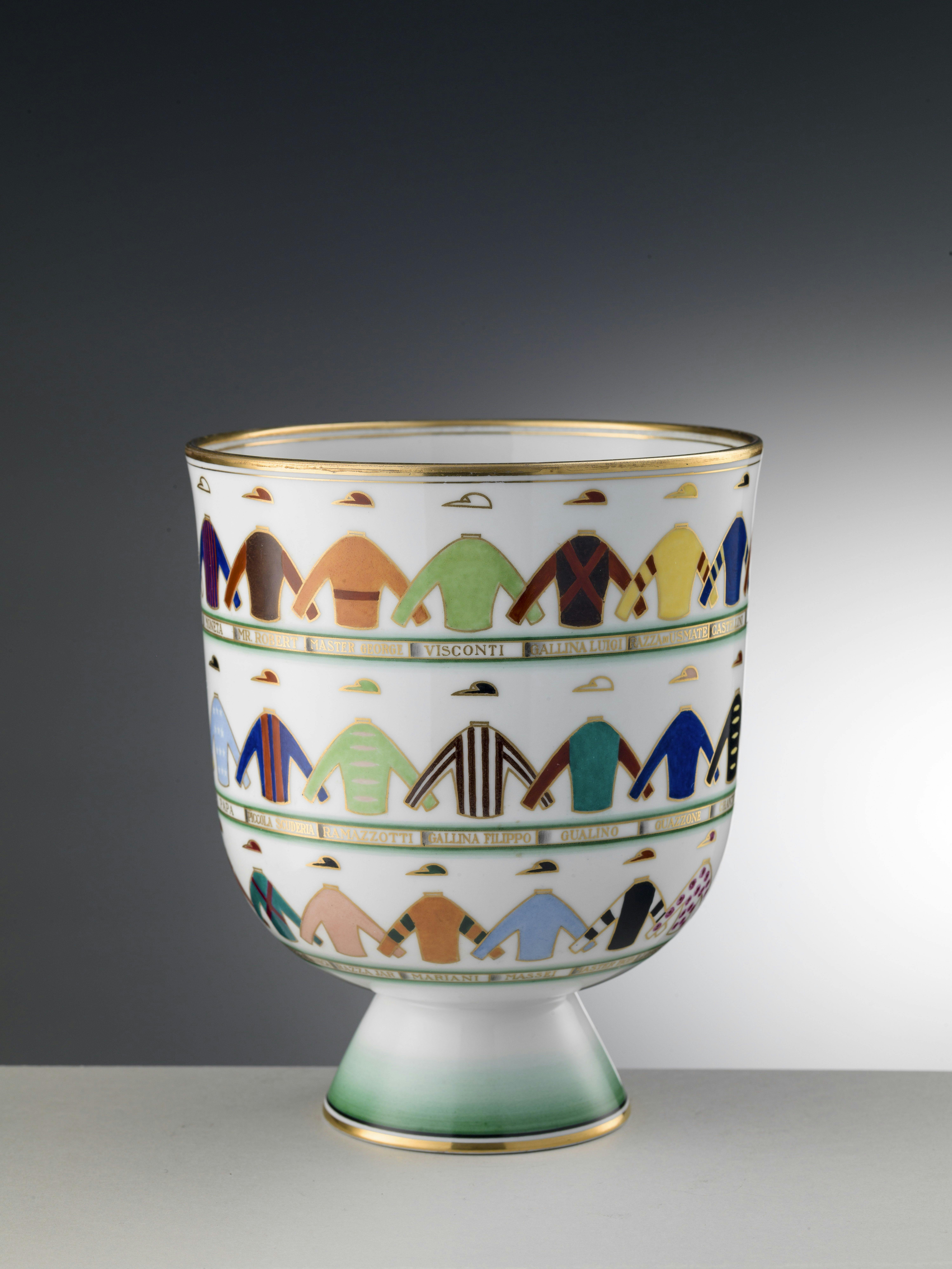 White cup decorated with three chains of colorful jockey silks