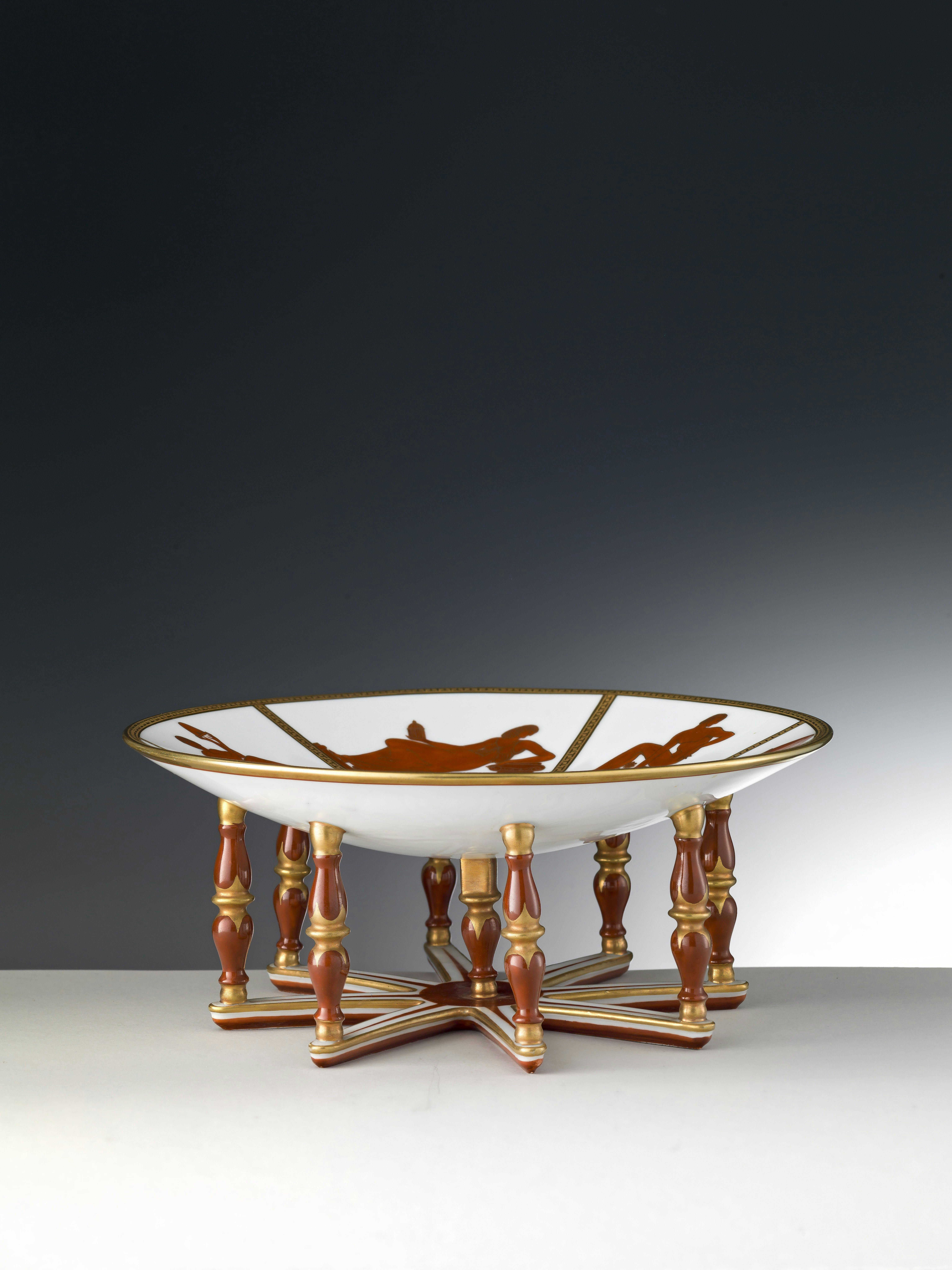 White stand with red and gold allegorical decorations.