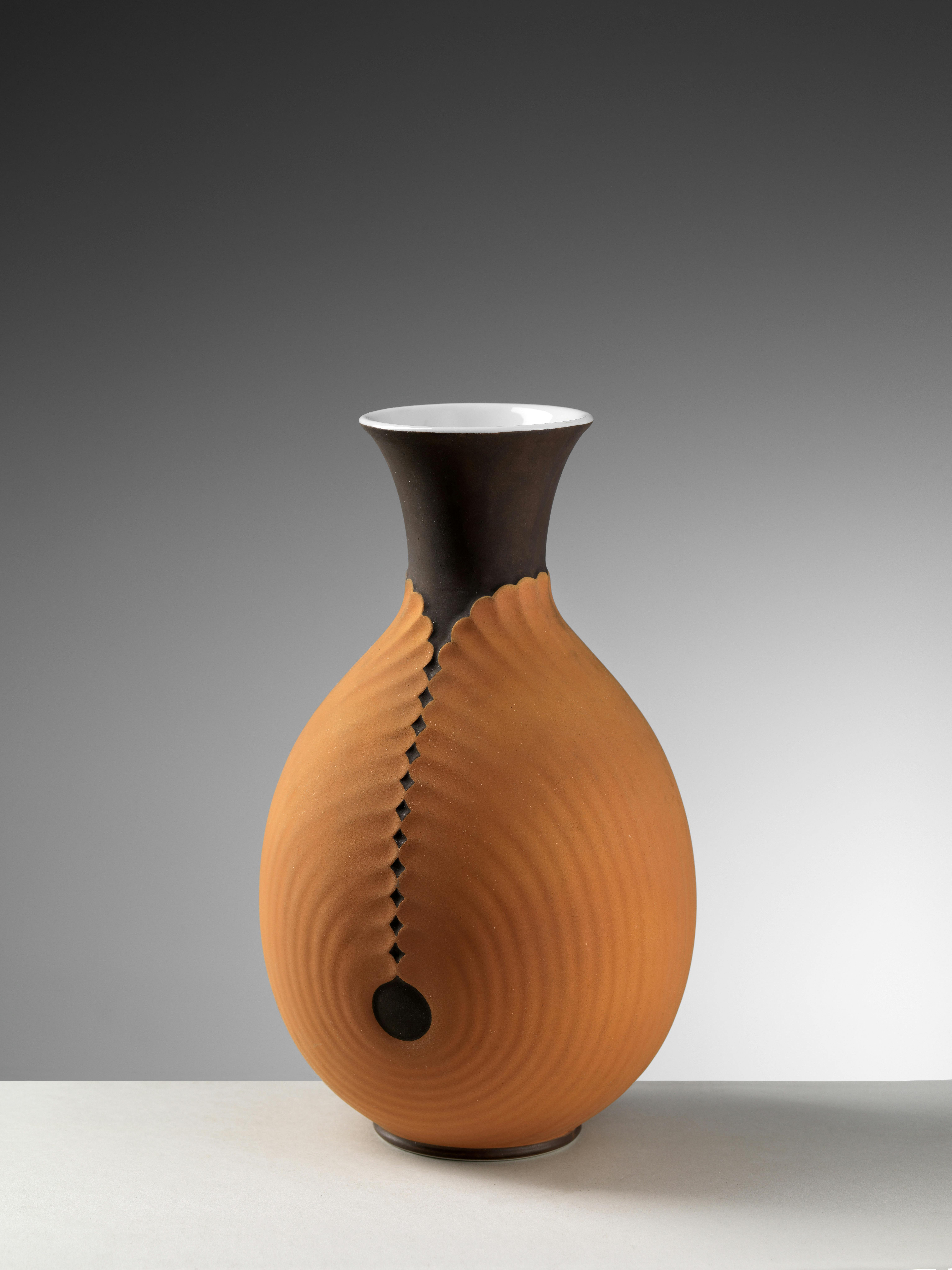Vase with a light relief decoration that covers it like a shell up to the neck