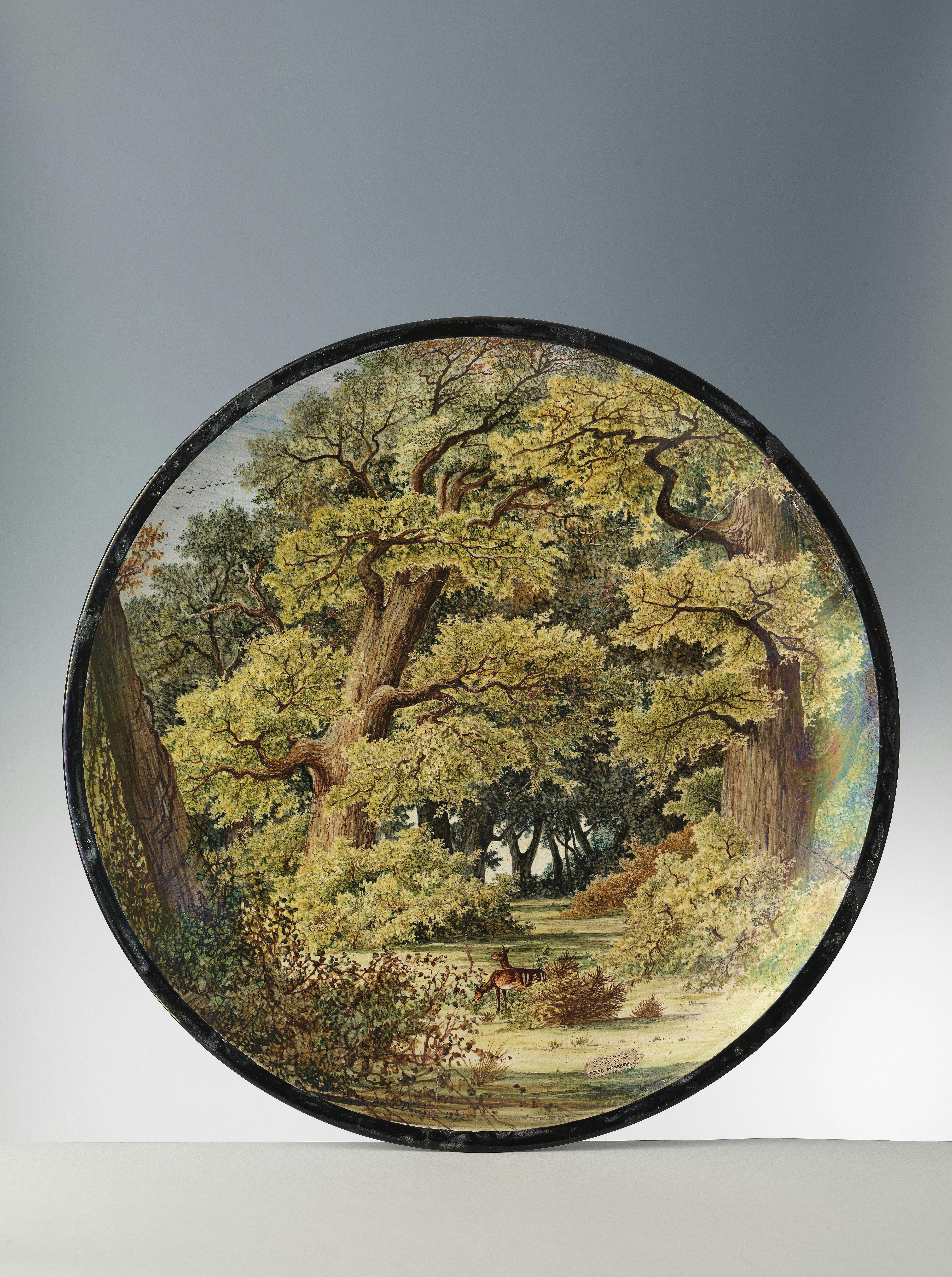 The plate is entirely decorated with the depiction of a forest with tall trees