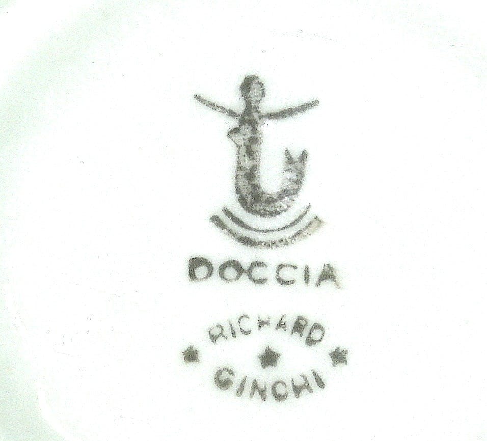 Stylized mermaid with 'Doccia' inscription below and Richard Ginori stamp with three stars.