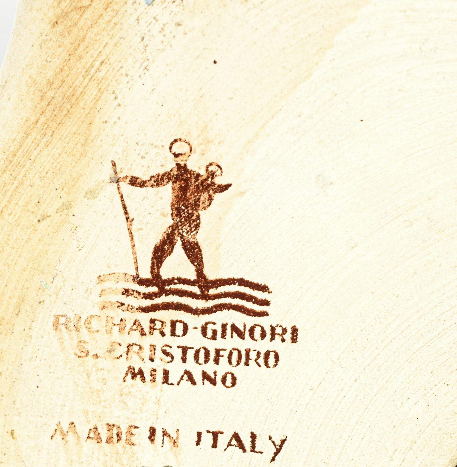Stylized figure of St. Christopher among the waves, with factory stamp below and 'Made in Italy' inscription.