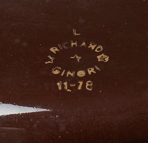 Stamp with letters, numbers, and a star in the center.