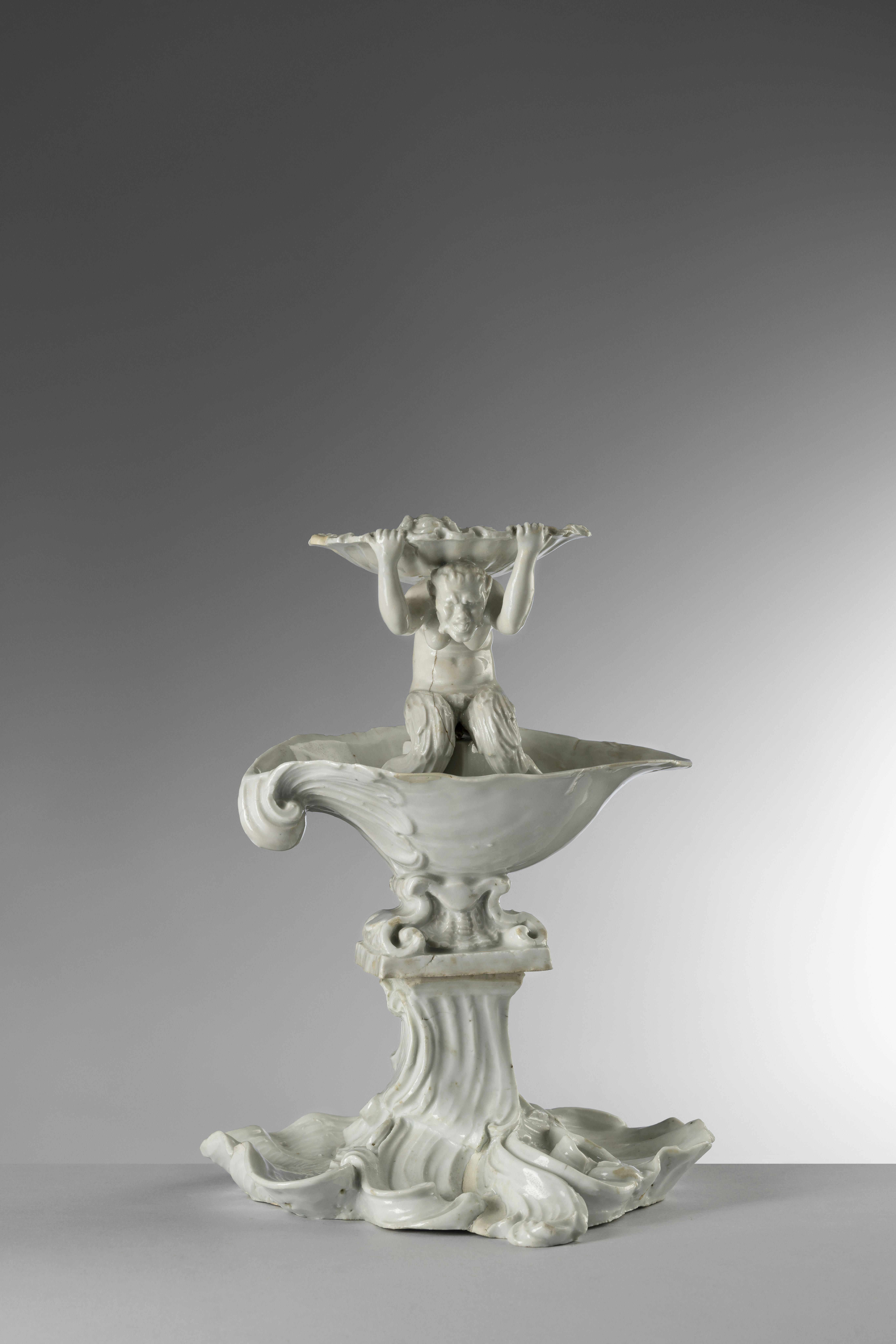 White porcelain tazza with a Triton figure on top