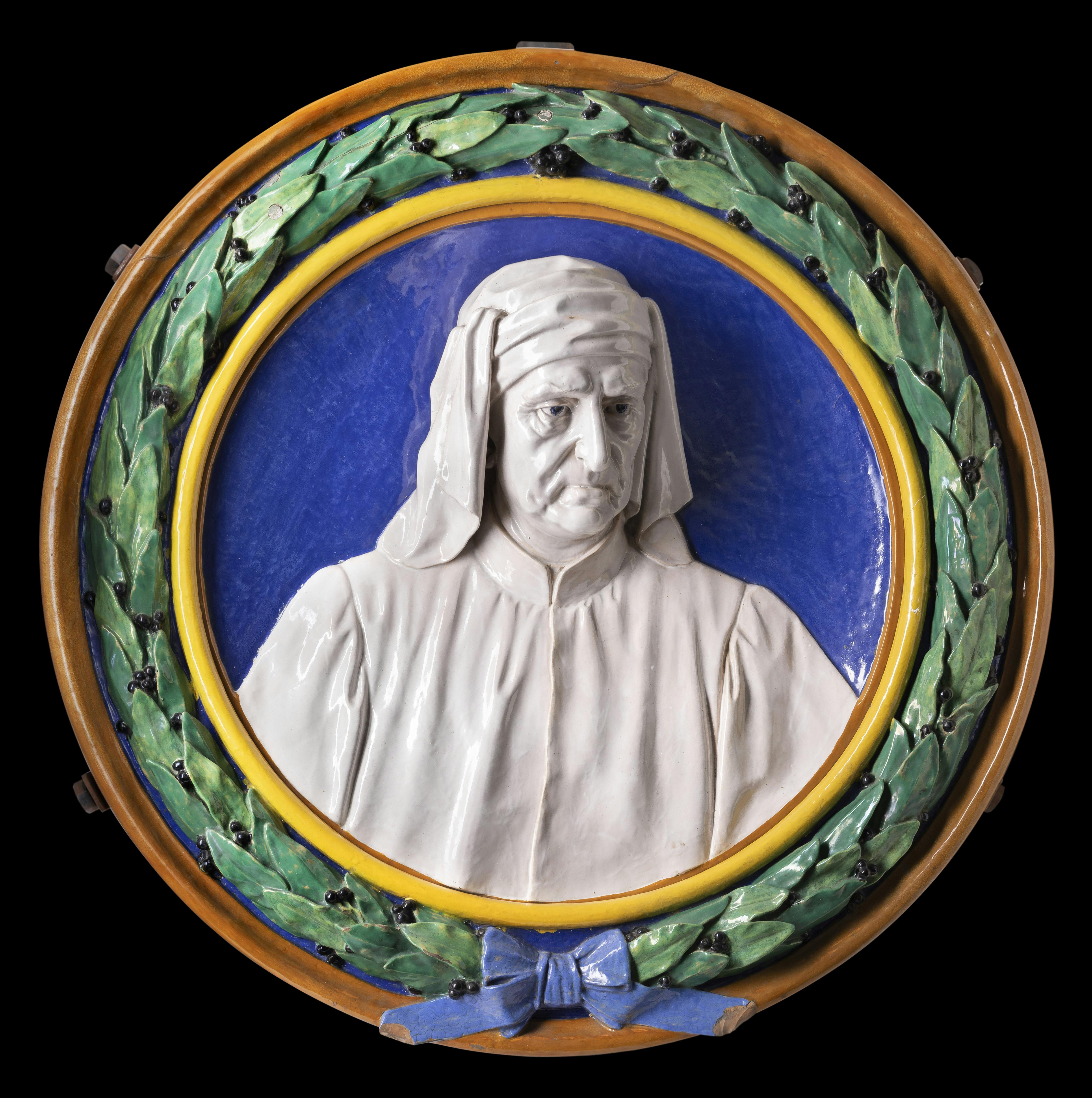 Tondo borsato d'alloro, con busto di uomo in maiolica bianca su fondo blu