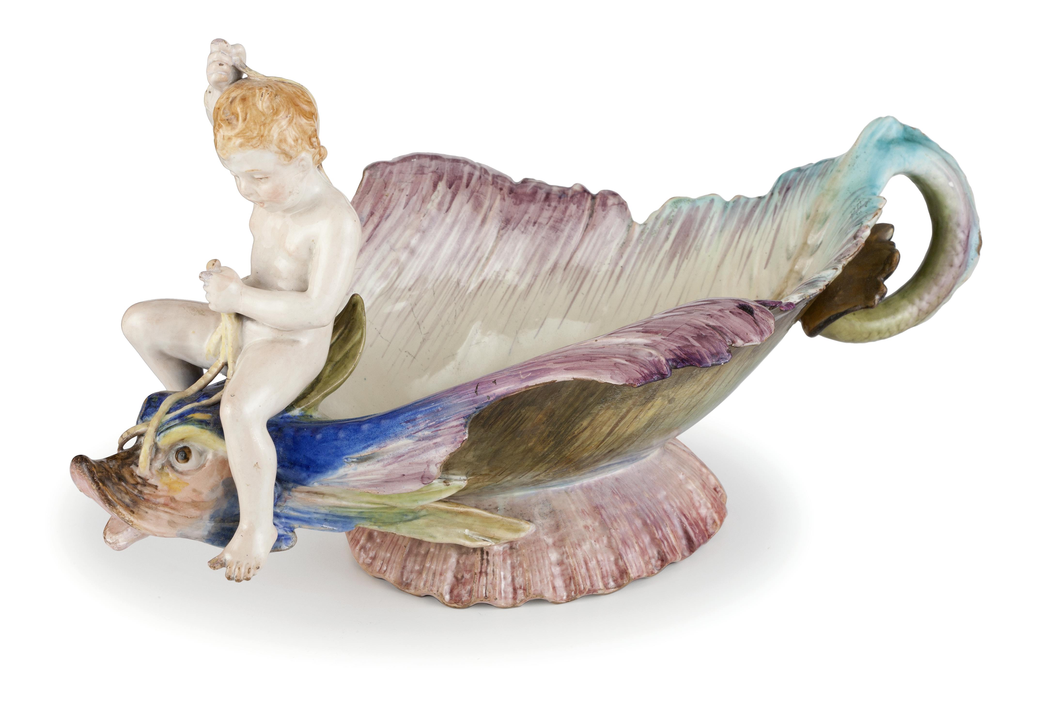 recipiente a forma di pesce colorato cavalcato da un putto