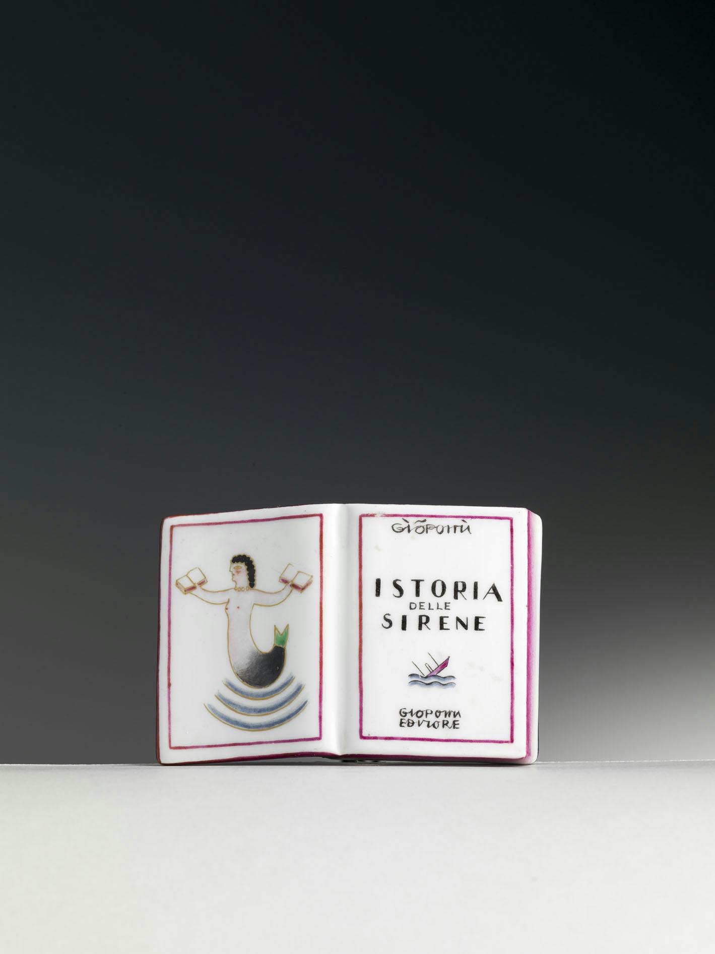 Book-shaped paperweight with text and illustration