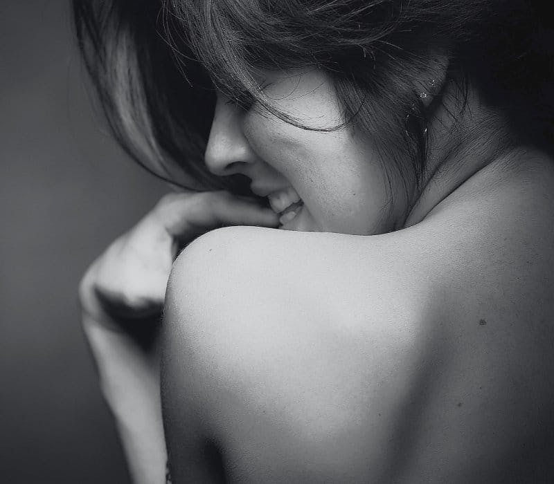 View of womans shoulder and face from the back
