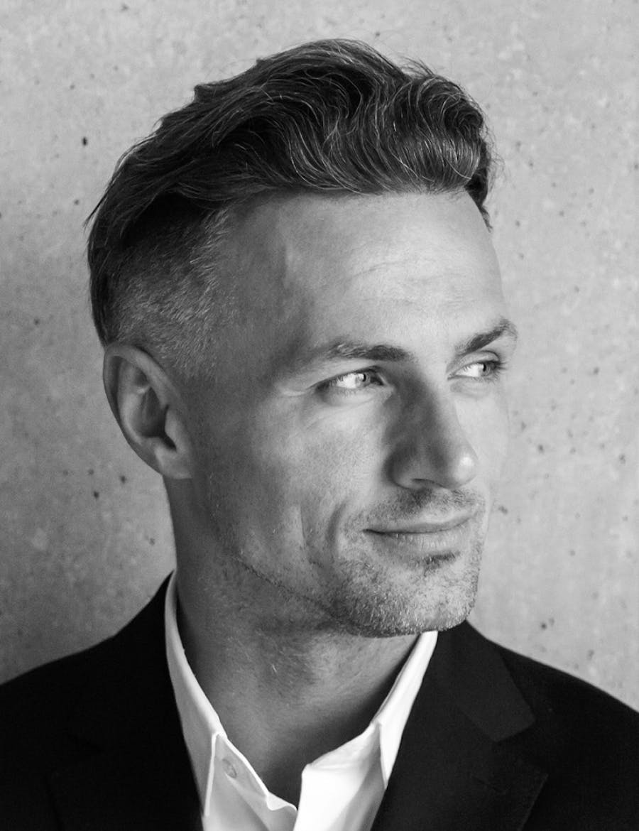 Headshot of a man looking off to the side.