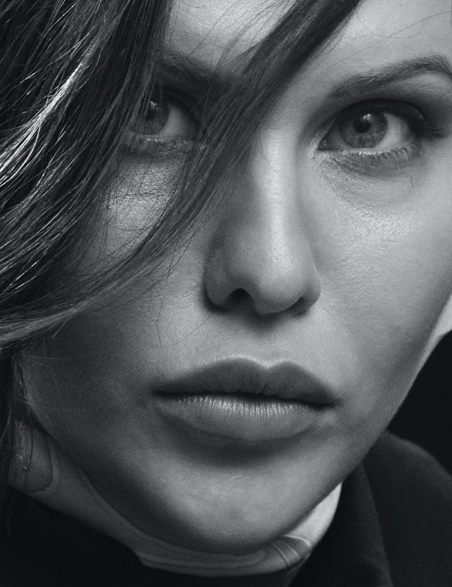 Close up of a woman's face partially covered with hair.