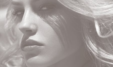 Closeup of a blonde with a sidelong glance.