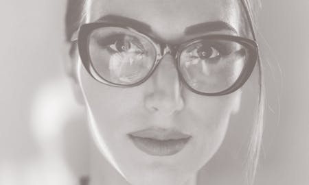 Woman's face with glasses on.