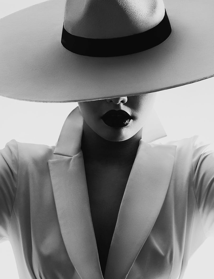 Woman with a wide-brimmed hat that is covering her eyes.