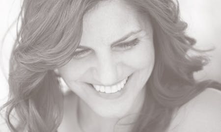 Smiling woman looking down.