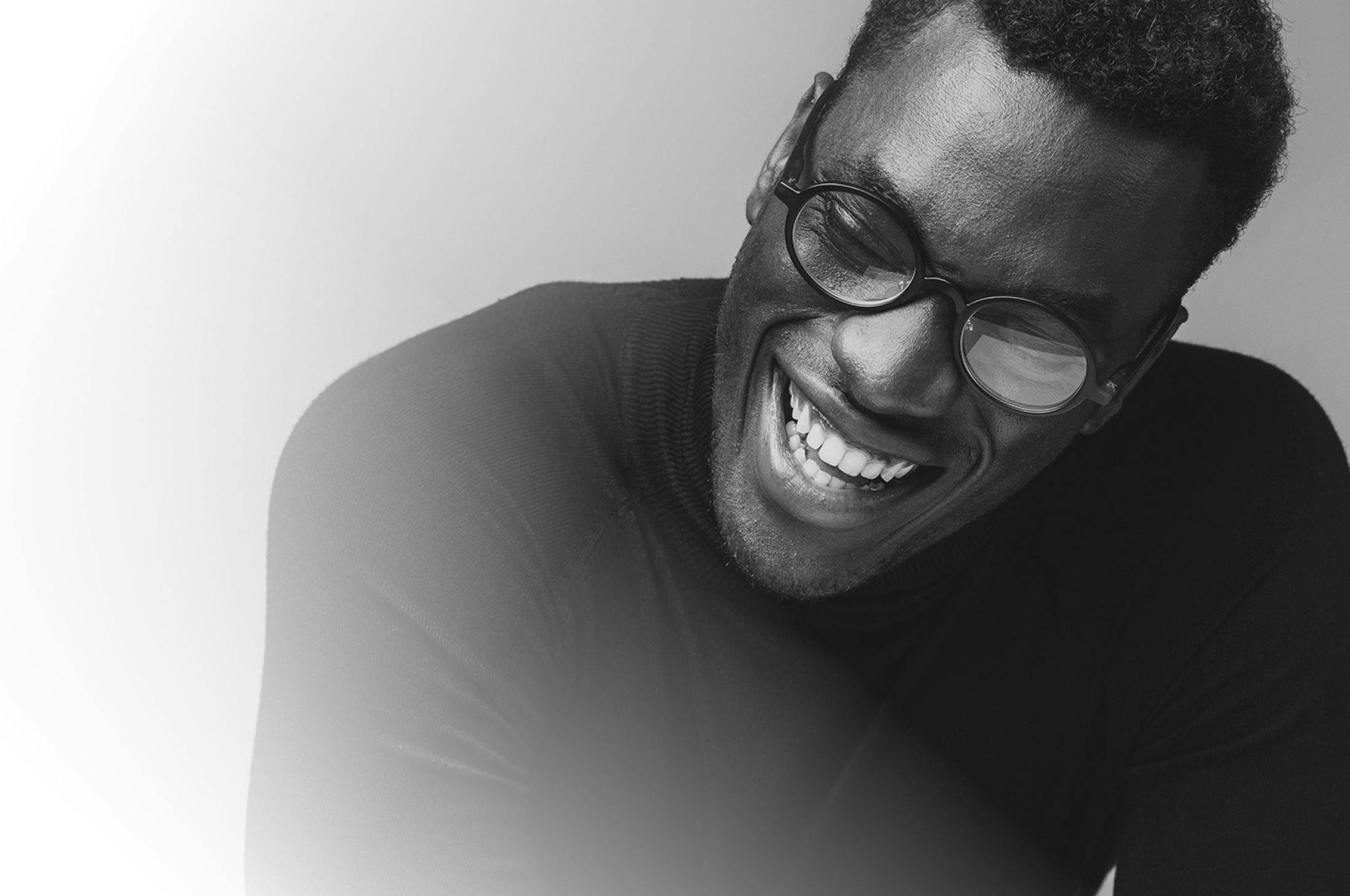 Smiling man with glasses.