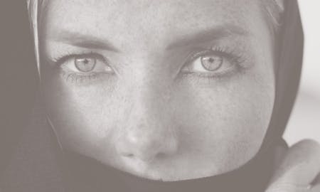 Woman with mouth and hair covered, eyes and nose showing.