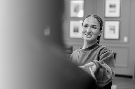 Woman handing over a tablet