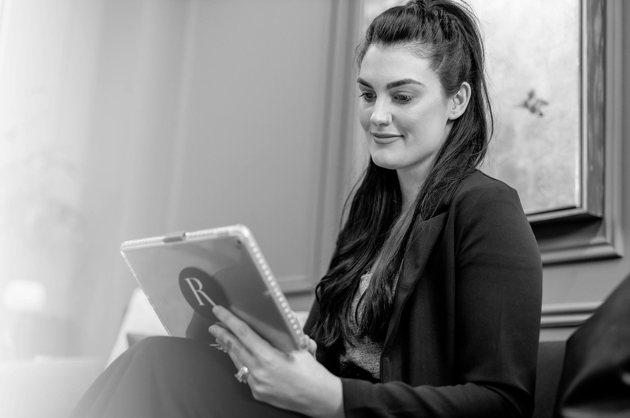 Woman reading testimonials on tablet