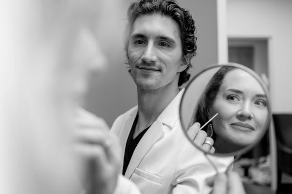 Dr Lucas Bryant, facial plastic surgeon in Nashville, working with a patient.