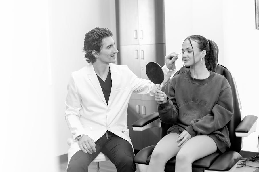 Dr Lucas Bryant, facial plastic surgeon in Nashville, sitting next to a patient.