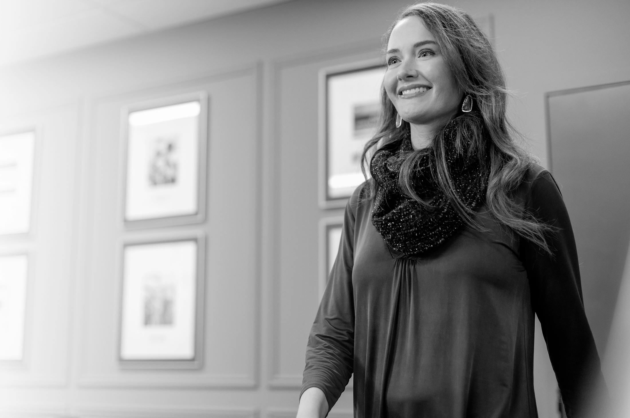 Woman smiling, wearing a scarf