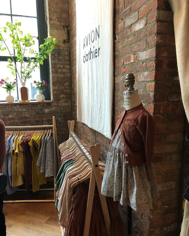 wood clothing racks displaying merchandise