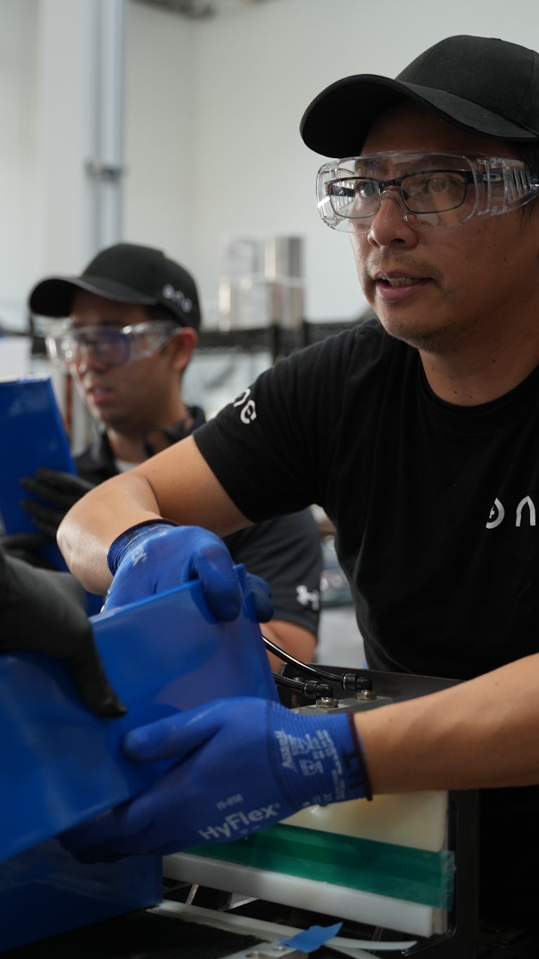 Production line workers assembling ONE batteries
