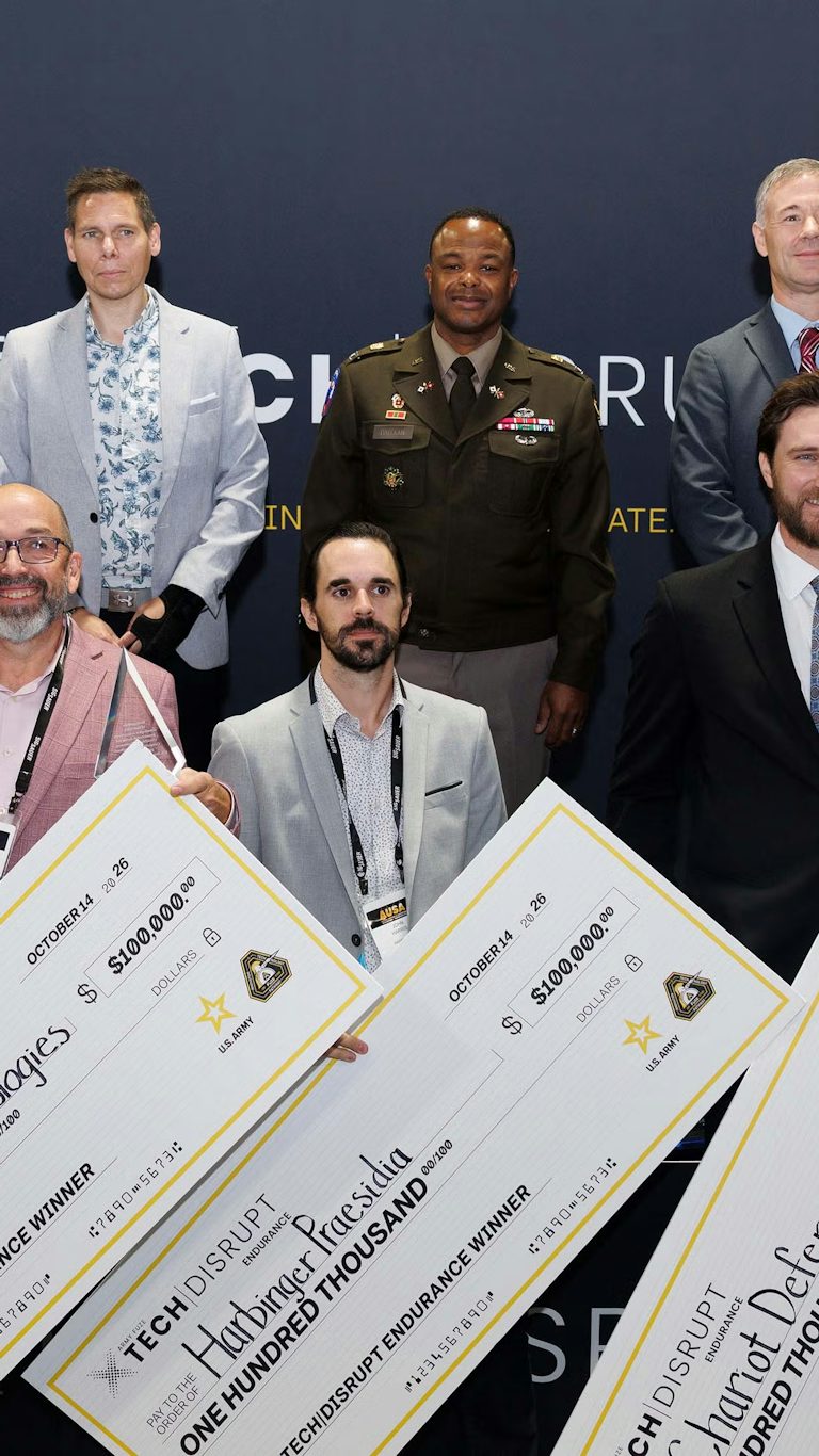 Kyle Maxwell of ONE accepts the Army's Xtech Disrupt Endurance $100k prize on behalf of ONE at AUSA 2026 in Washington, D.C.