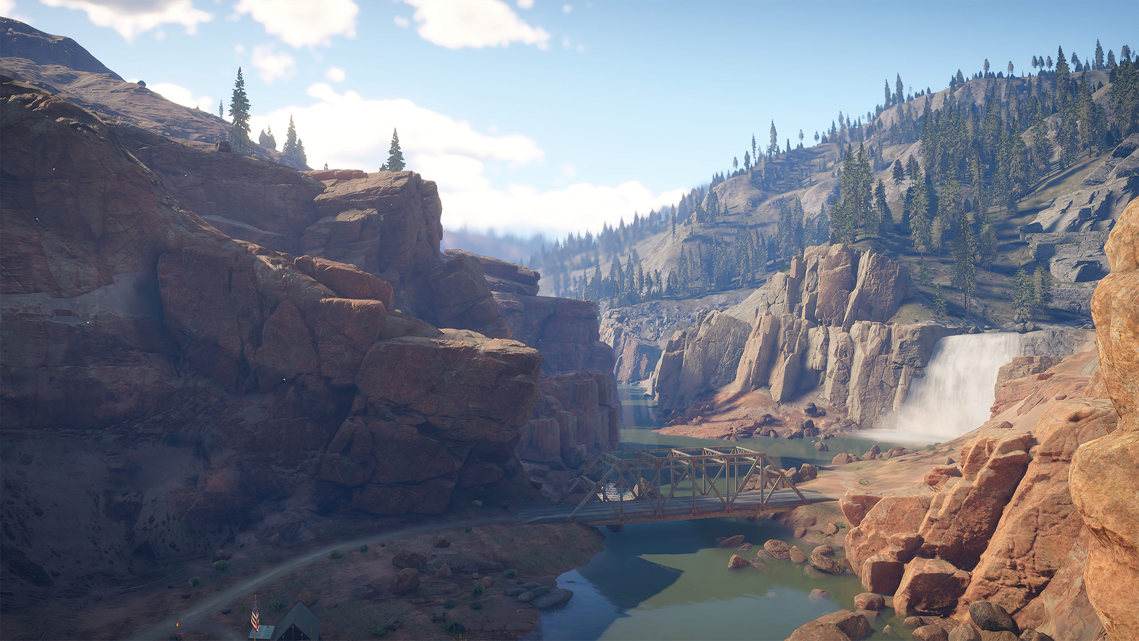 A screenshot of a waterfall and bridge in a canyon in Golden Ridge Reserve, taken after The Challenger Update.