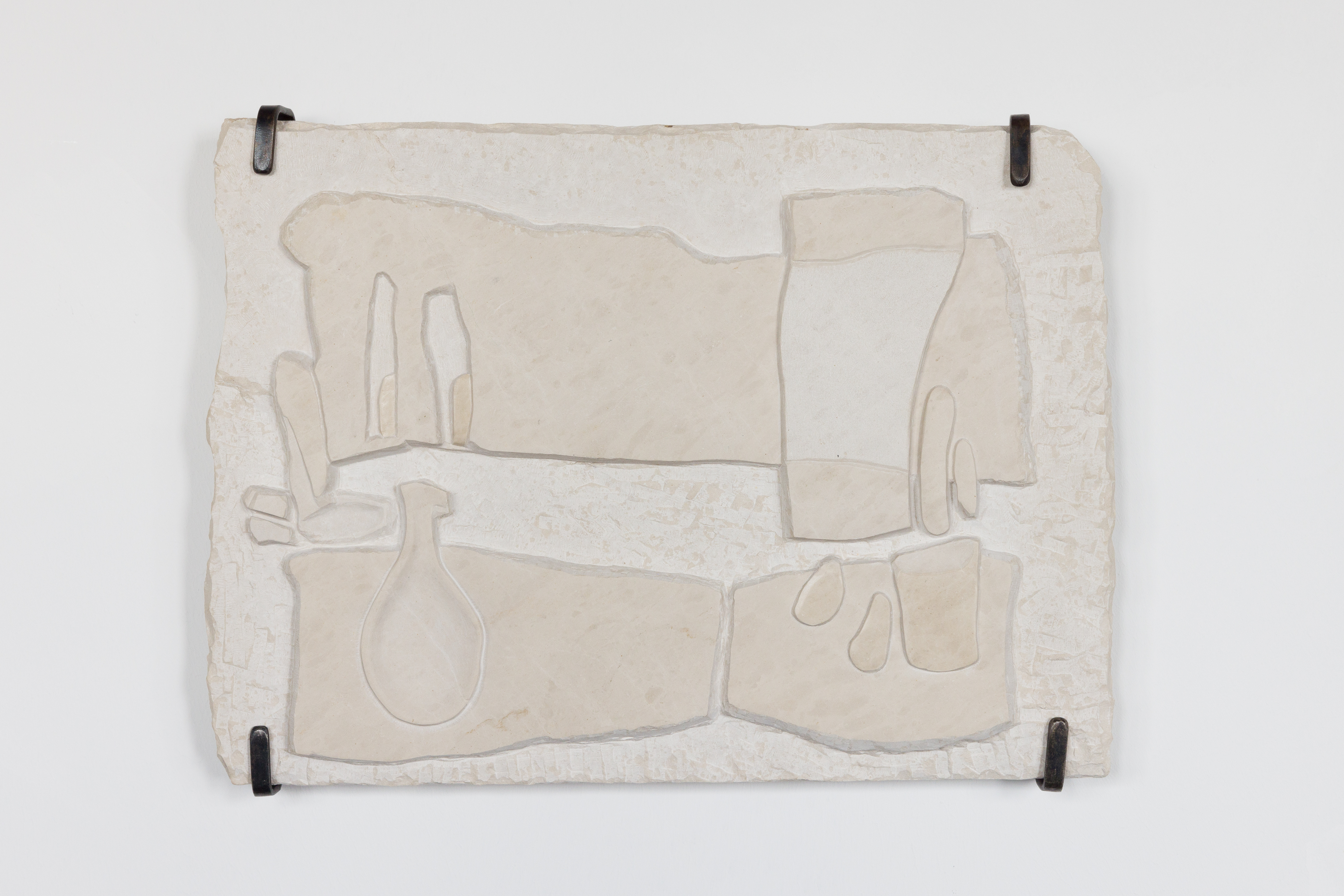 Relief in limestone, metal hanger