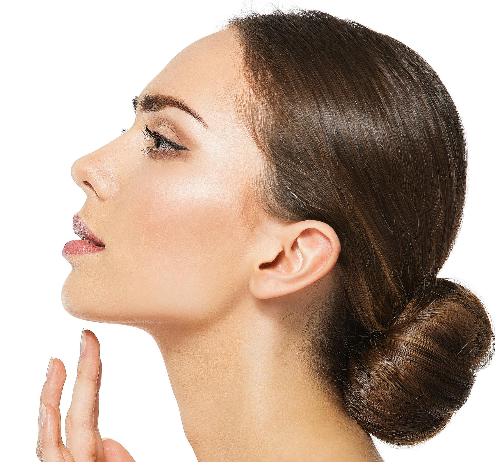 Brunette woman's face from a side view.