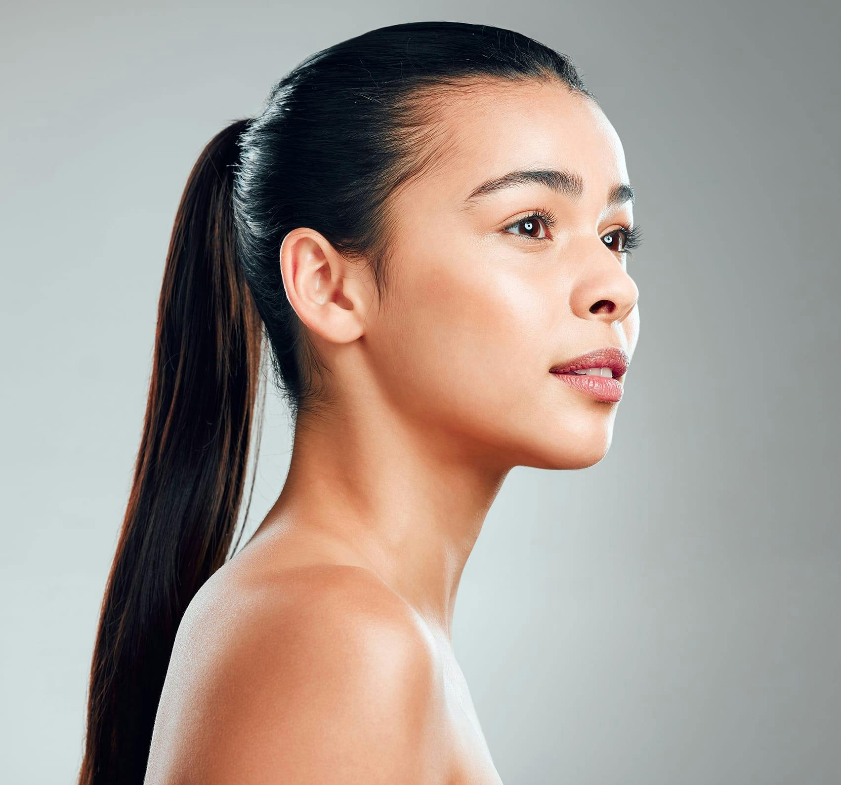 Pretty woman with a ponytail looking to the side.