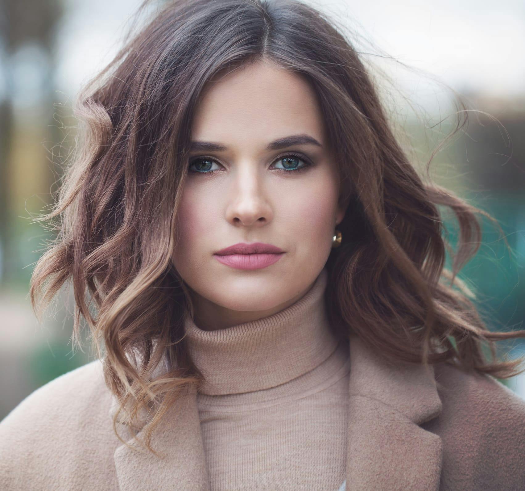 Brunette woman looking forward.