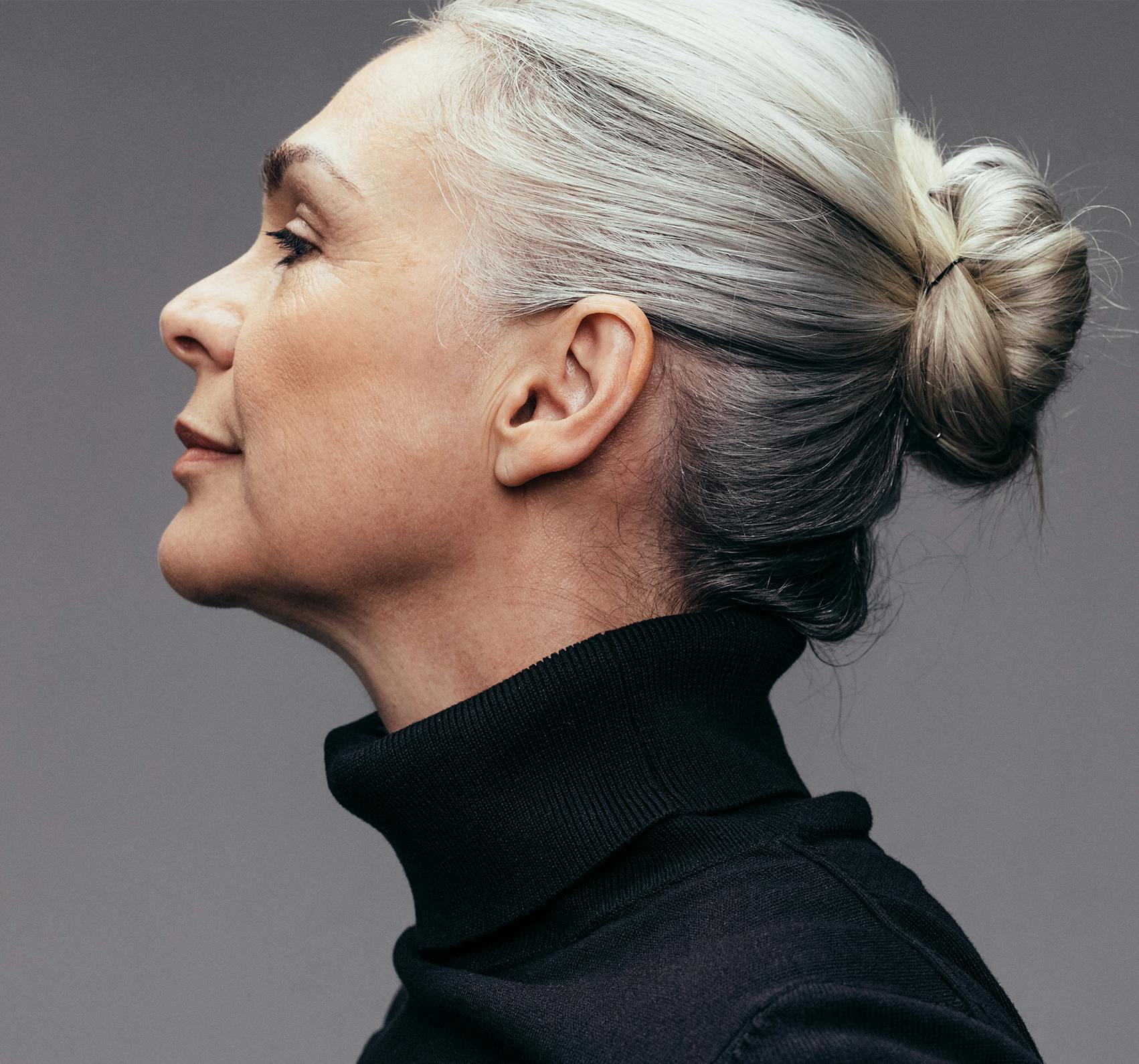 Middle aged woman with gray hair. Side view.
