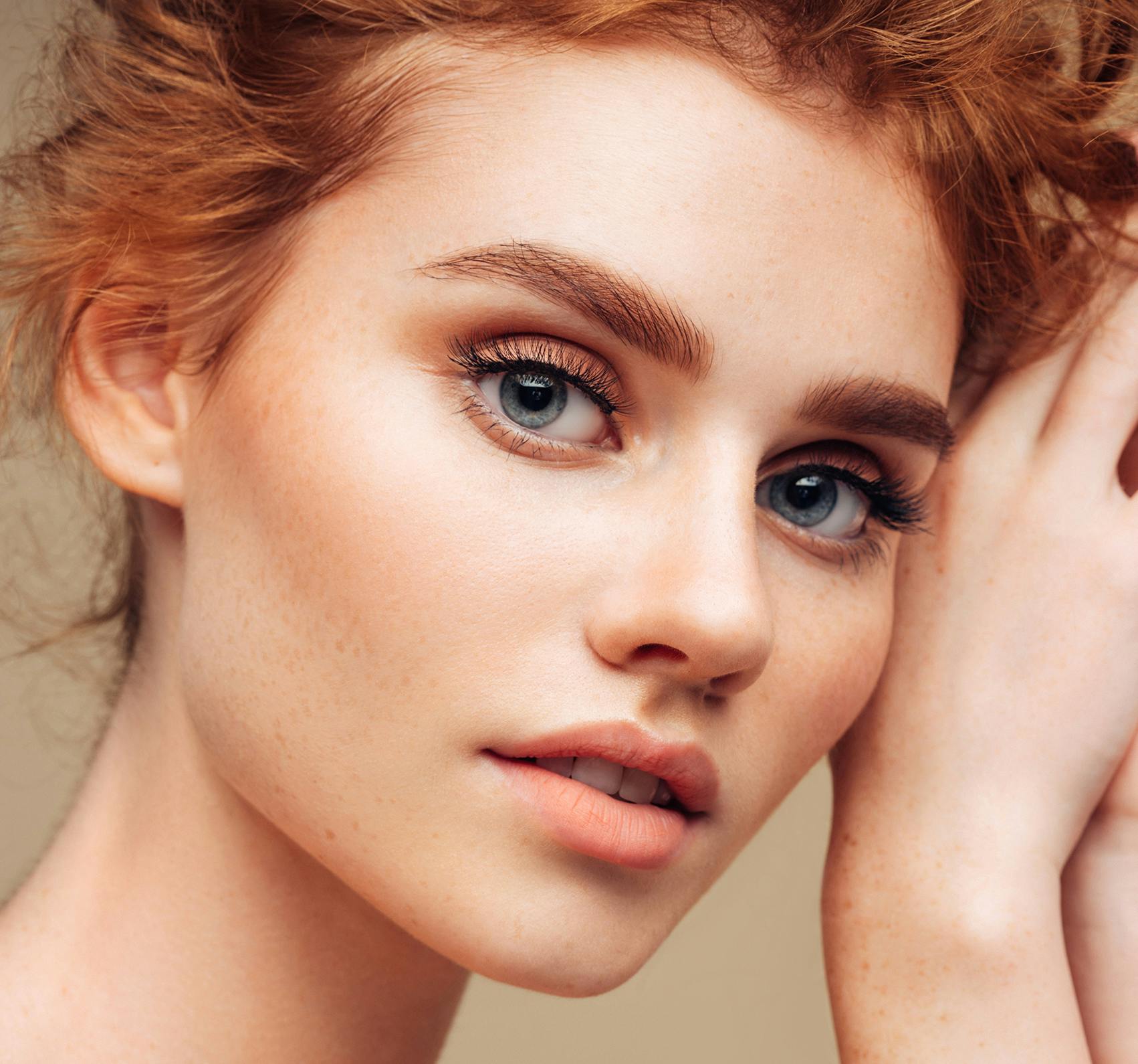 Young red haired woman looking at the camera.