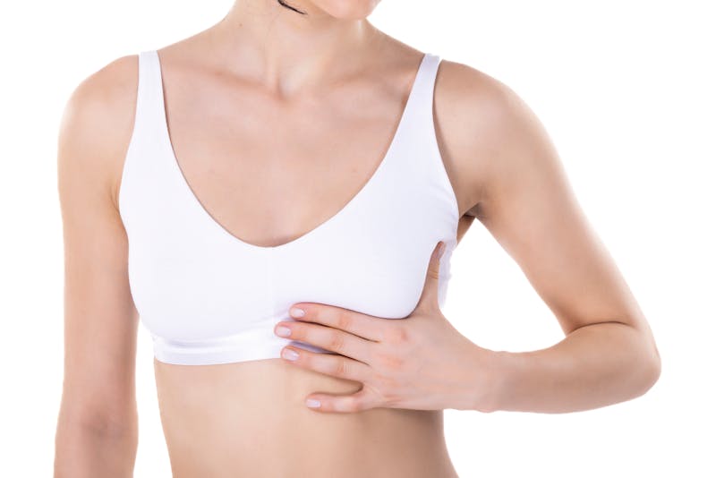 woman touching her breast