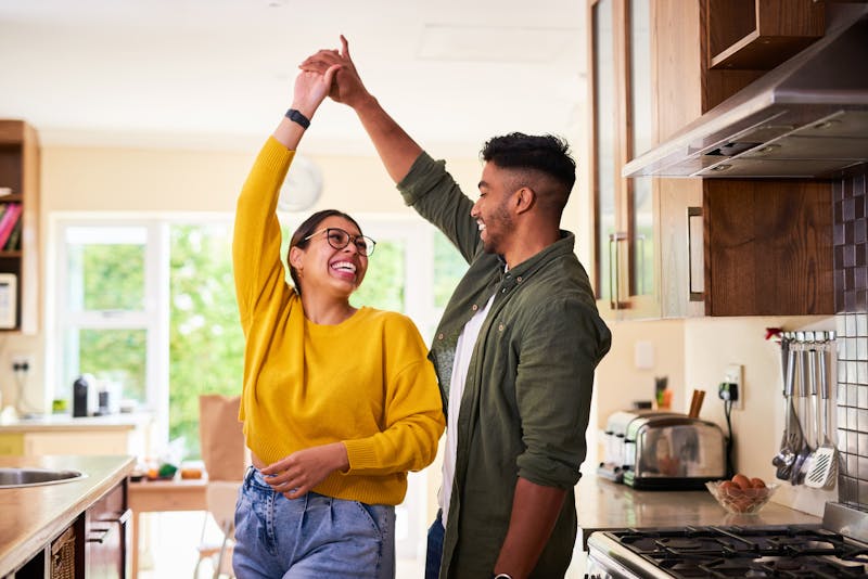 happy couple dancing in the kitchen