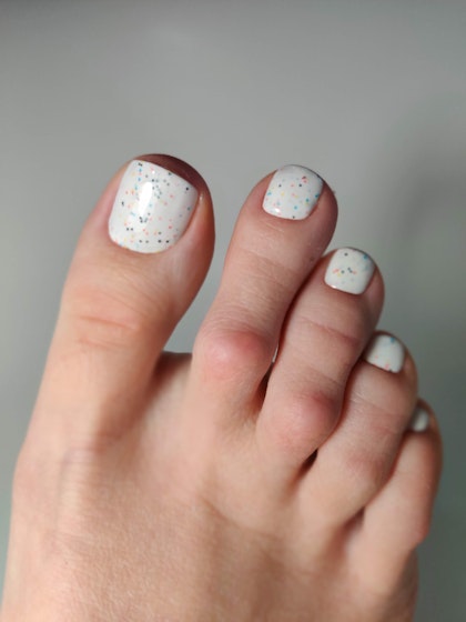 White pedicure with color crumbs