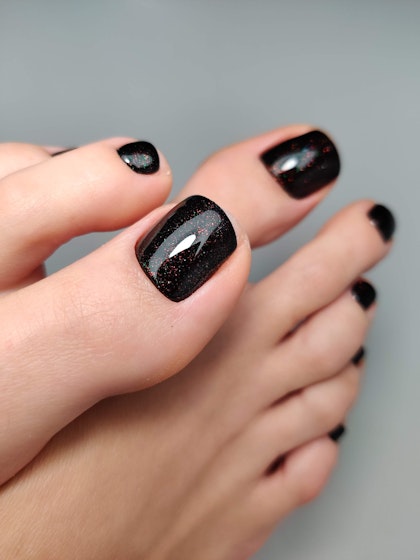 Dark pedicure with a perfect crimson sheen