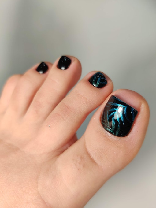 Shiny pedicure with azure shimmer - plants on the background