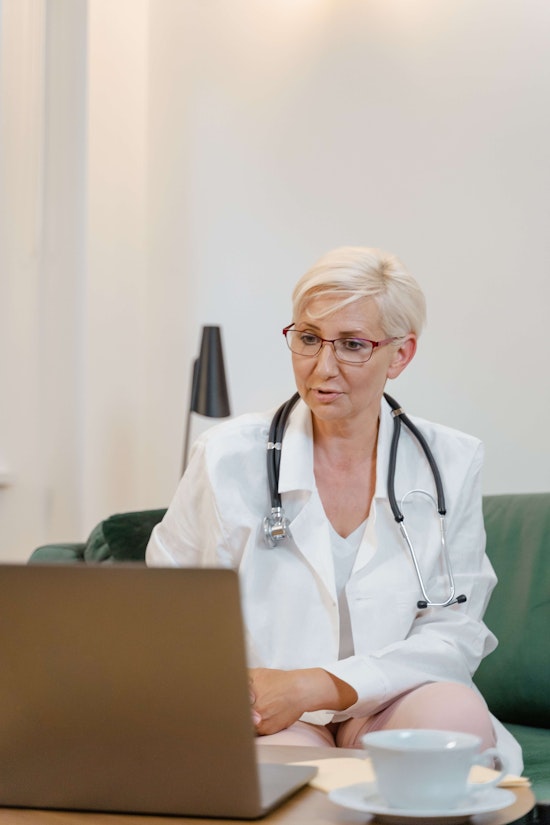 provider sitting behind a laptop to provide online care