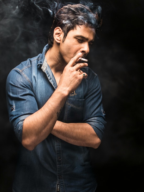 Man Smoking on Dark Background