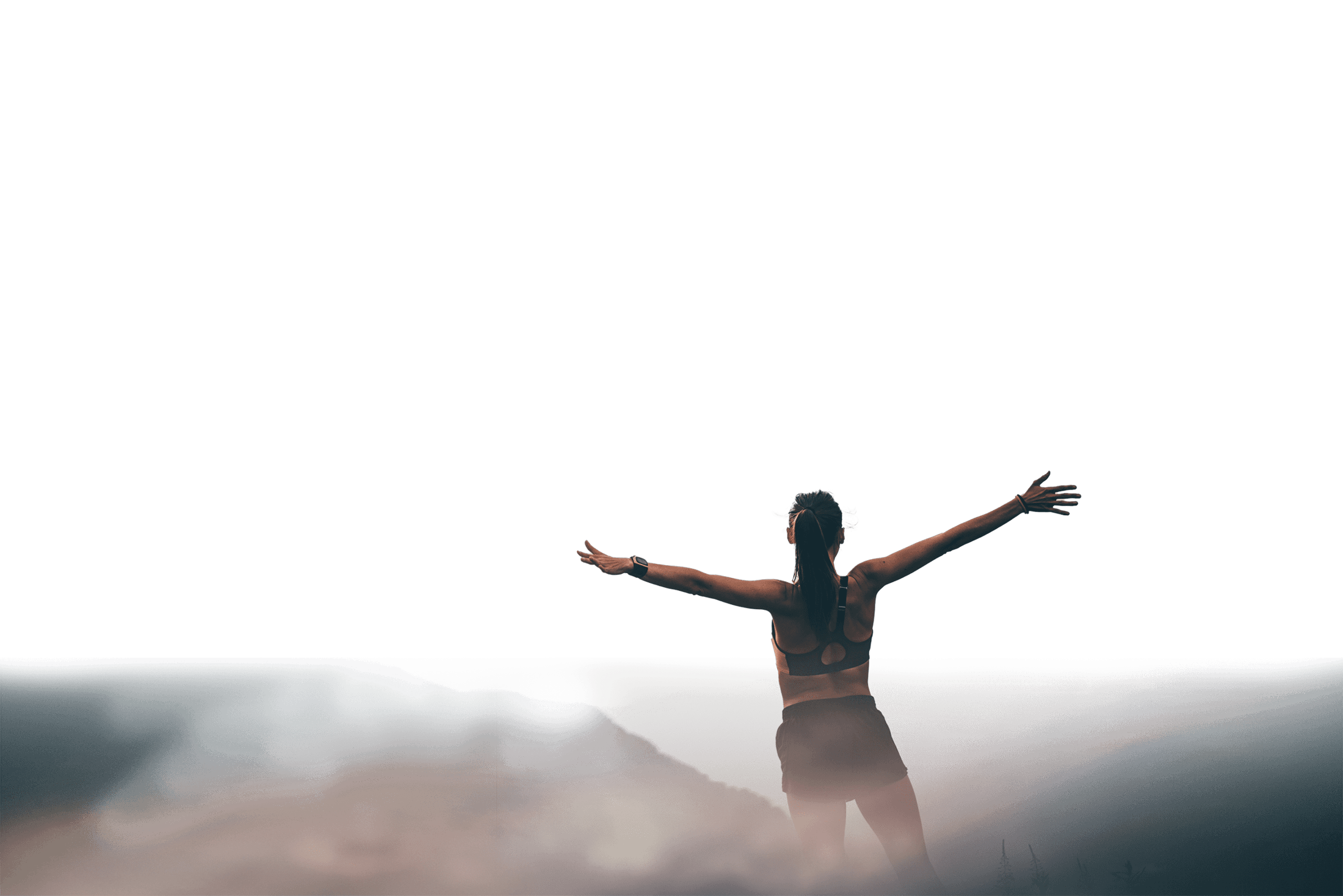 Woman with her arms spread out to the side after a hike