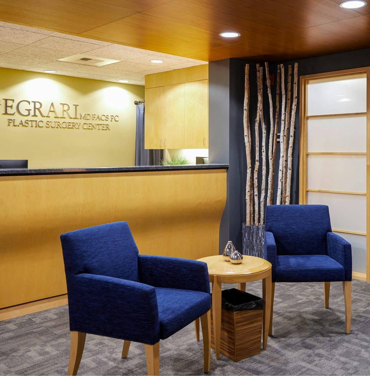 our Seattle office waiting room, two chairs with night stand and receptionist desk